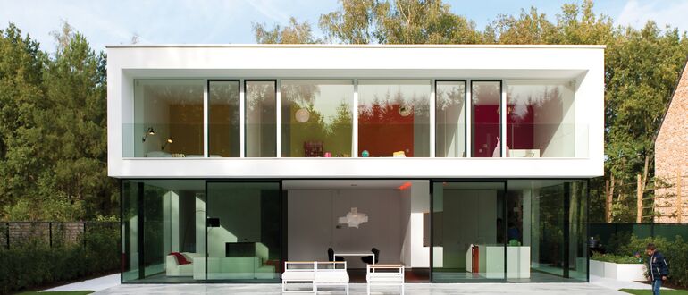 White luxurious villa with green garden.